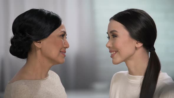 Mother Feels Happiness for Her Daughter, Expressing Love, Touching Forehead alt