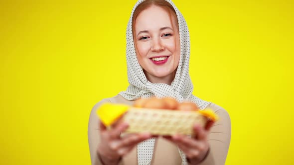 Rack Focus Smiling Young Redhead Woman in Kerchief Stretching Eggs To Camera alt