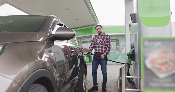 Portrait of a Young Handsome Bearded Caucasian Man with Glasses He is Standing alt