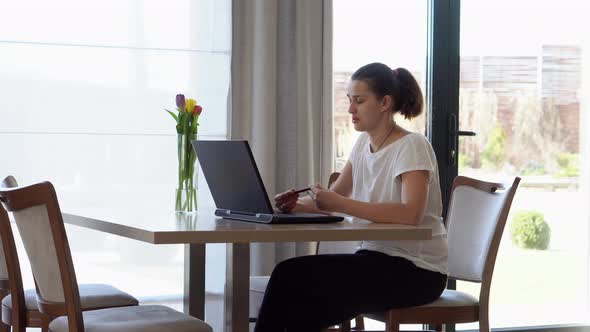 Authentic Caucasian Young Woman Chatting On Laptop At Home In Living Room