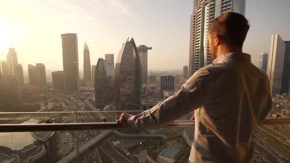 Business Man Overlooking Cityscape while Working in Corporate Building alt