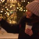 Young Smiling Woman Holding Burning Sparkler and Coffee in Cold Winter Evening on Street - VideoHive Item for Sale