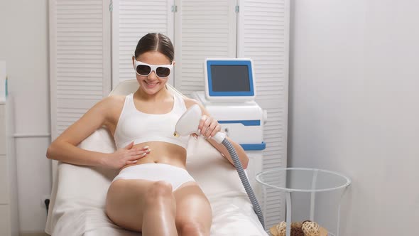 Attractive Lady in Protective Eyeglasses, Get Hair Removal Procedure. alt