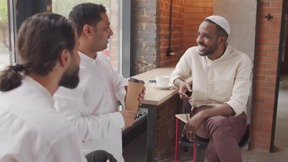 Multiethnic Men Talking in Cafe alt