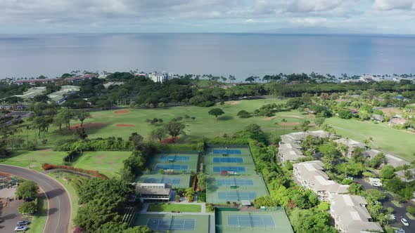 Aerial View of Tennis and Golf Courses in Sport Club on Tropical Island Hawaii alt