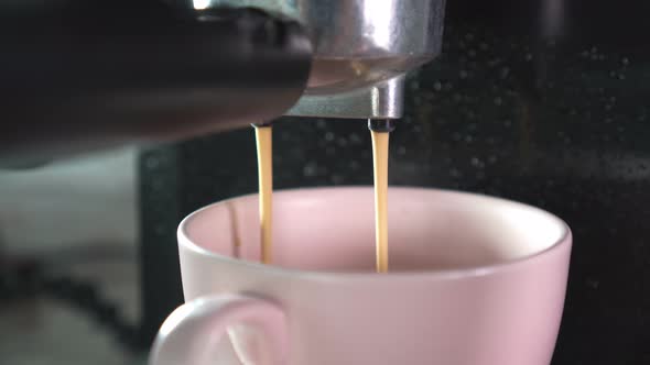 Footage B Roll of Pouring coffee stream from machine in cup. Home making hot Espresso.