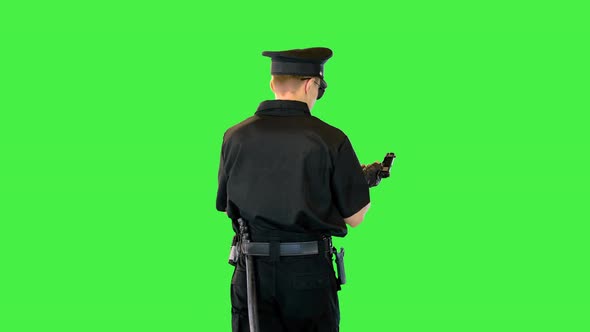 Caucasian Policeman Walks Gets the Gun Out Reloads and Puts It Back on a Green Screen Chroma Key alt