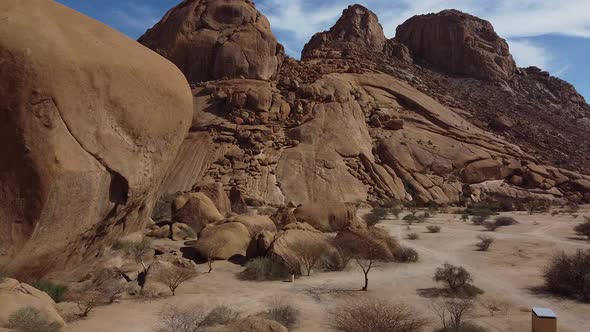 Massive round rocks and huge mountains, Erongo, Namibia, aerial shot alt