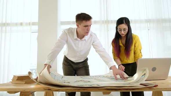 Team designers office with large windows brainstorming. Meeting of design team alt