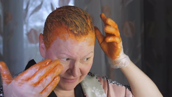 Spreading Out the Dye Color Onto the Hair of the Lady