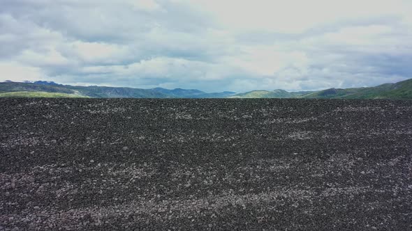 Massive rocky man-made landfill at Hardangervidda - Approaching wall of stone while descending - Sym alt
