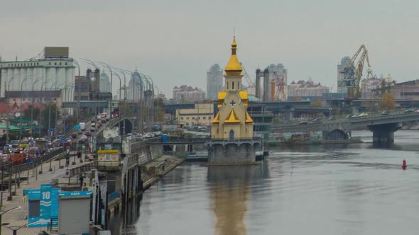 The Bustle Of A Big City Near The River Bank With Bridges, Cloudy Weather, Kiev