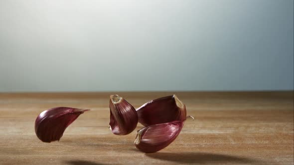 Garlic clove pieces bouncing in ultra slow motion  alt