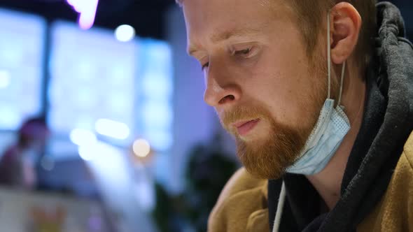 portrait of a man with a protective mask on his chin