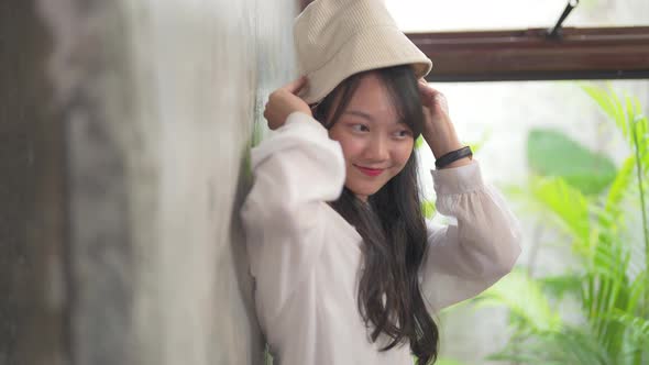 4K Point of view portrait of Young Asian woman looking and playing with camera. alt