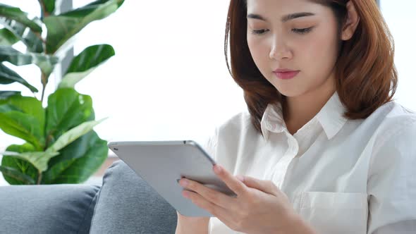 Asian woman using digital tablet shopping online, call, texting message internet 