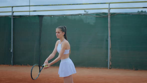 Outside on the Clay Court Female Tennis Player alt