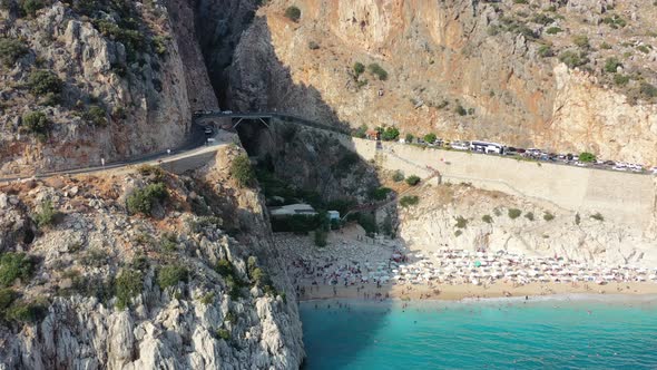 Aerial of European tourists sun bathing at Kaputas on a white sandy beach with turquoise blue water alt