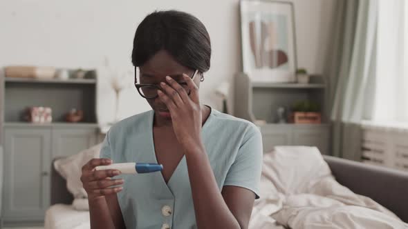 Woman Is Sad because of Negative Pregnancy Test Result alt