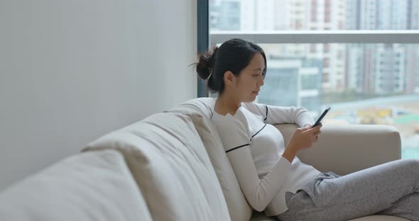 Woman use of smart phone at home alt