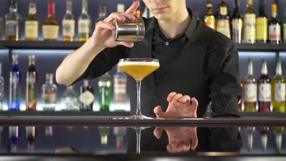 Bartender Making Fresh Alcoholic Cocktail on Bar Counter