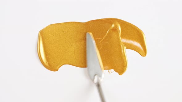 Abstract Brushstrokes of Gold Paint Brush Applied Isolated on a White Background alt