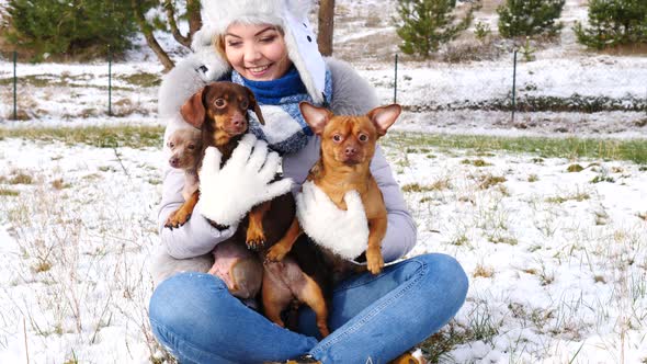 Woman Playing with Dogs Outside, Winter