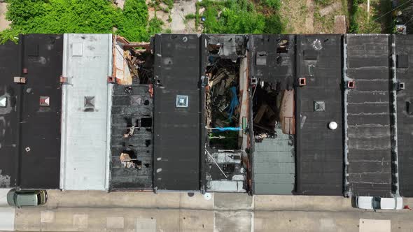 Rowhomes damaged and in disrepair in inner city in USA. American rowhouses abandoned in crime ridden alt