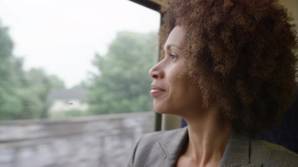 Afro American commuter on her way to work looking out of the window