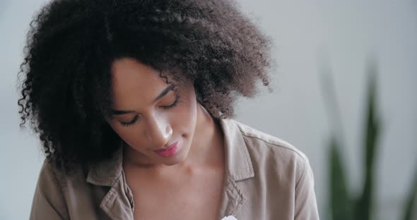 Head Shot Happy African Woman Reads Good News in Mail Letter Sits on Sofa at Home, Celebrating alt
