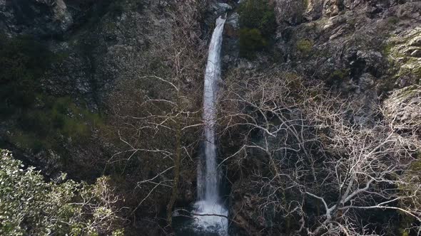 Beautiful Waterfall Between Cliffs, Aerial View, Drone Is Moving Back