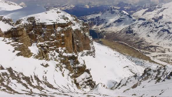 View of the snowy valley from the summit of Sass Pordoi in the Dolomites alt