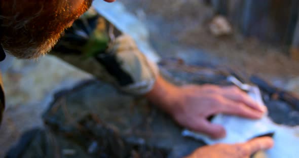 Man shaping animal skin in the forest 4k alt