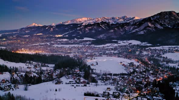 Aerial view of snowy sunset over Zakopane in winter alt