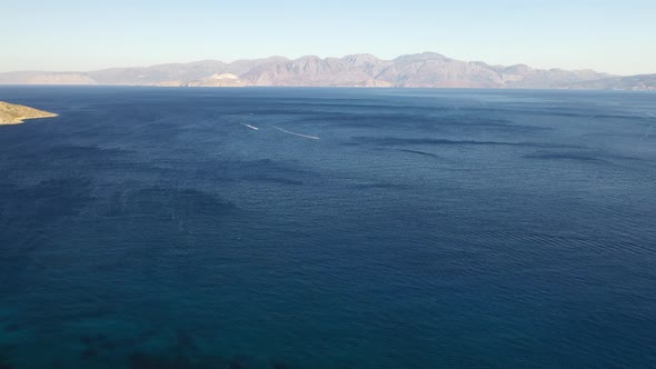 Aerial View of a Jet Ski Boat in a Deep Blue Colored Sea. Spinalonga Island, Crete, Greece