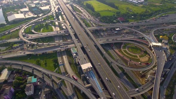 Aerial View of Highway Road Interchange with Busy Urban Traffic Speeding on Road alt