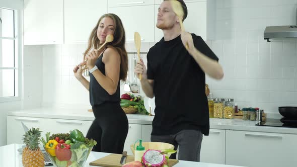Man and woman dancing in kitchen alt