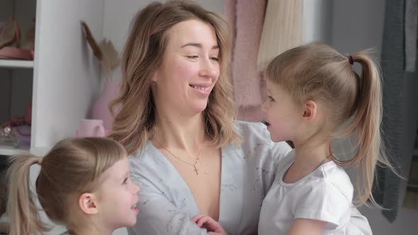 Stylish Mom and Her Twin Daughters are Happy in Her Cozy Apartment