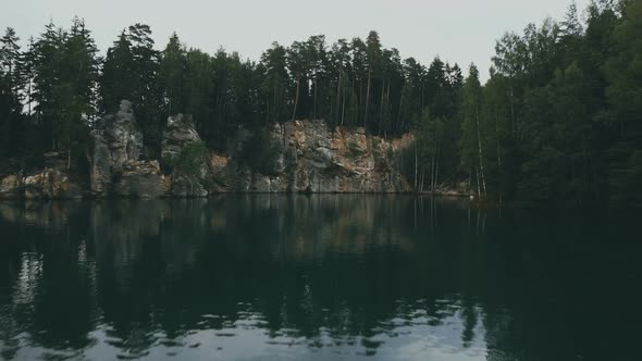 Adršpach-Teplice Rocks national park filmed from drone. Green forest with rocks and blue lake