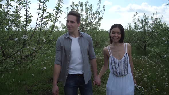 Romantic Couple in Love Taking a Walk in Orchard alt