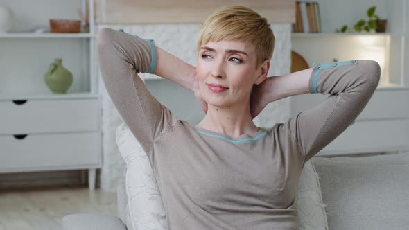 Serene Attractive Young Woman Resting on Couch Puts Hands Behind Head Closed Eyes Enjoy Fresh Air alt