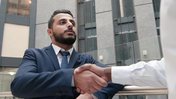 Arabian businessman shaking hands with colleague indoor