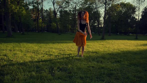 Handsome Young Girl Jumping and Dancing Outdoor in a Park alt