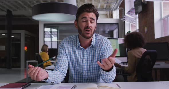 Happy caucasian businessman having video call sitting in front of computer alt