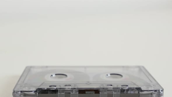 Vintage  compact  audio cassette on white background 4K 2160p 30fps UltraHD tilting footage - Transp