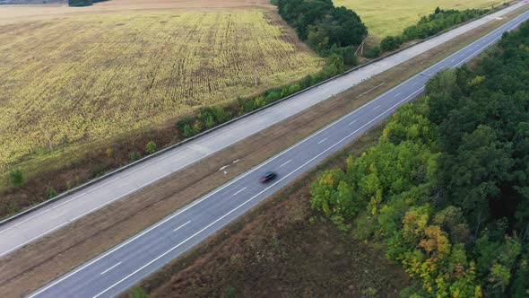 Long Twolane Concrete Road with Traffic in Rural Area alt