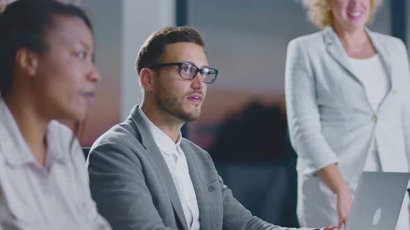 Man speaking to colleagues at meeting