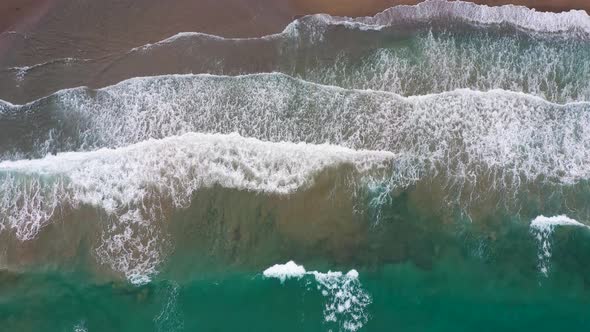 Aerial View of the Mediterranean Coast Waves Reach the Deserted Sandy Beach alt