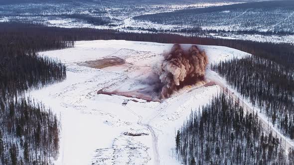 Explosion of a Mineral Deposits. Mined Territory in Field in Forest in Winter. Coal Mining