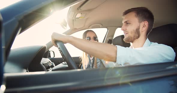 Couple Driving Car on Sunset